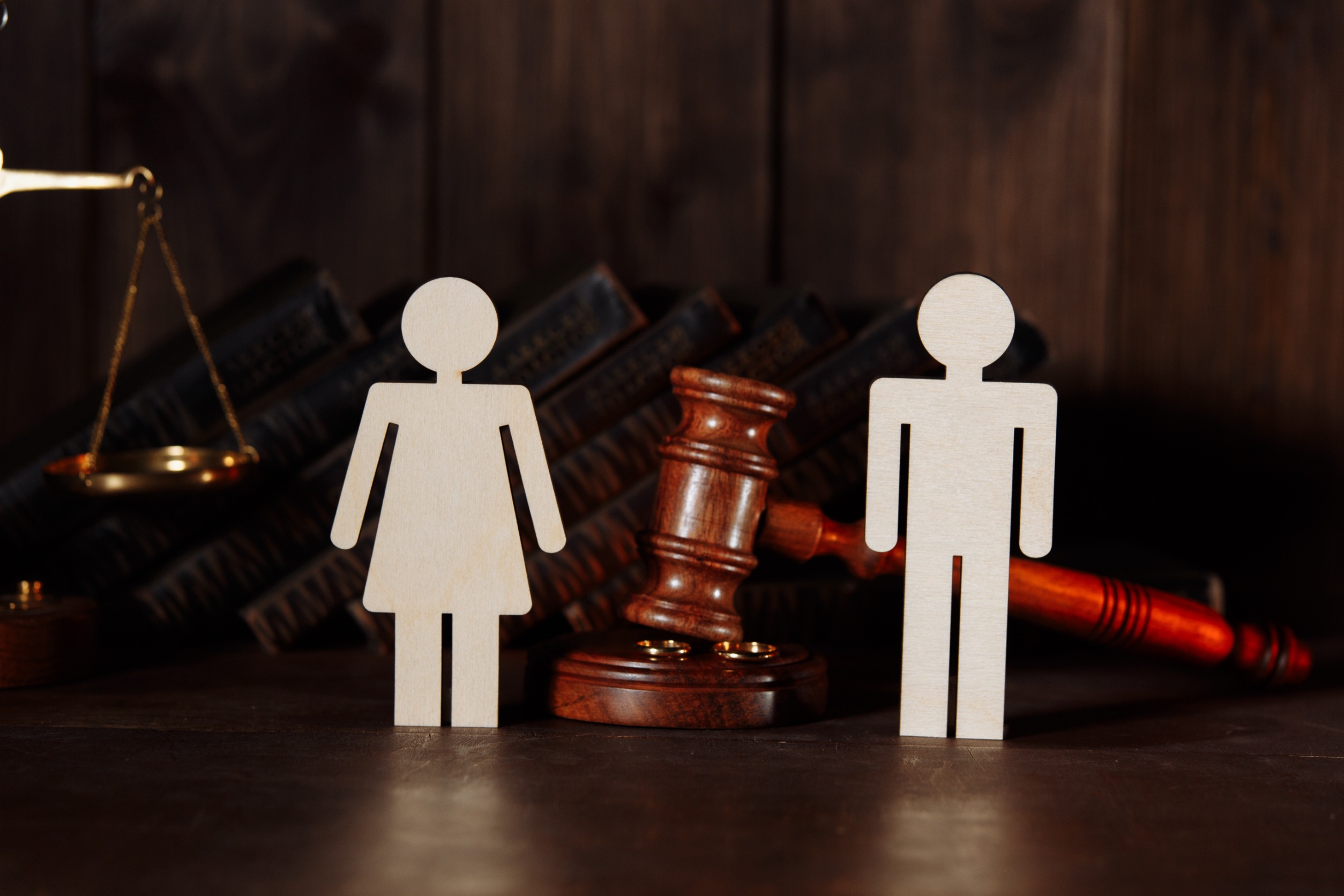 Couple figures with judge gavel. Divorce concept disputes in Family Law